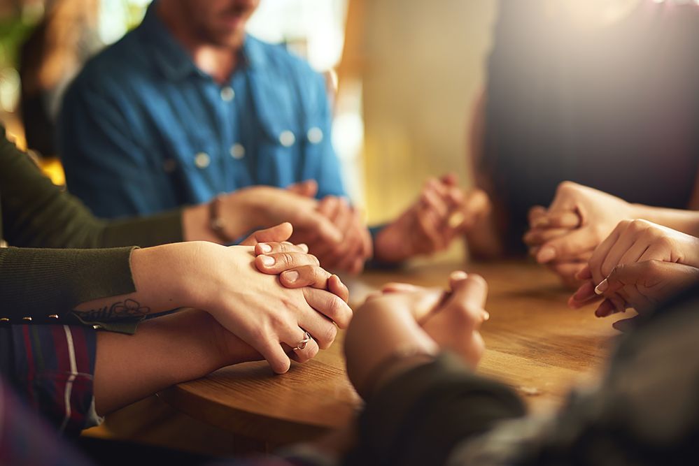 group prayer faith holding hands